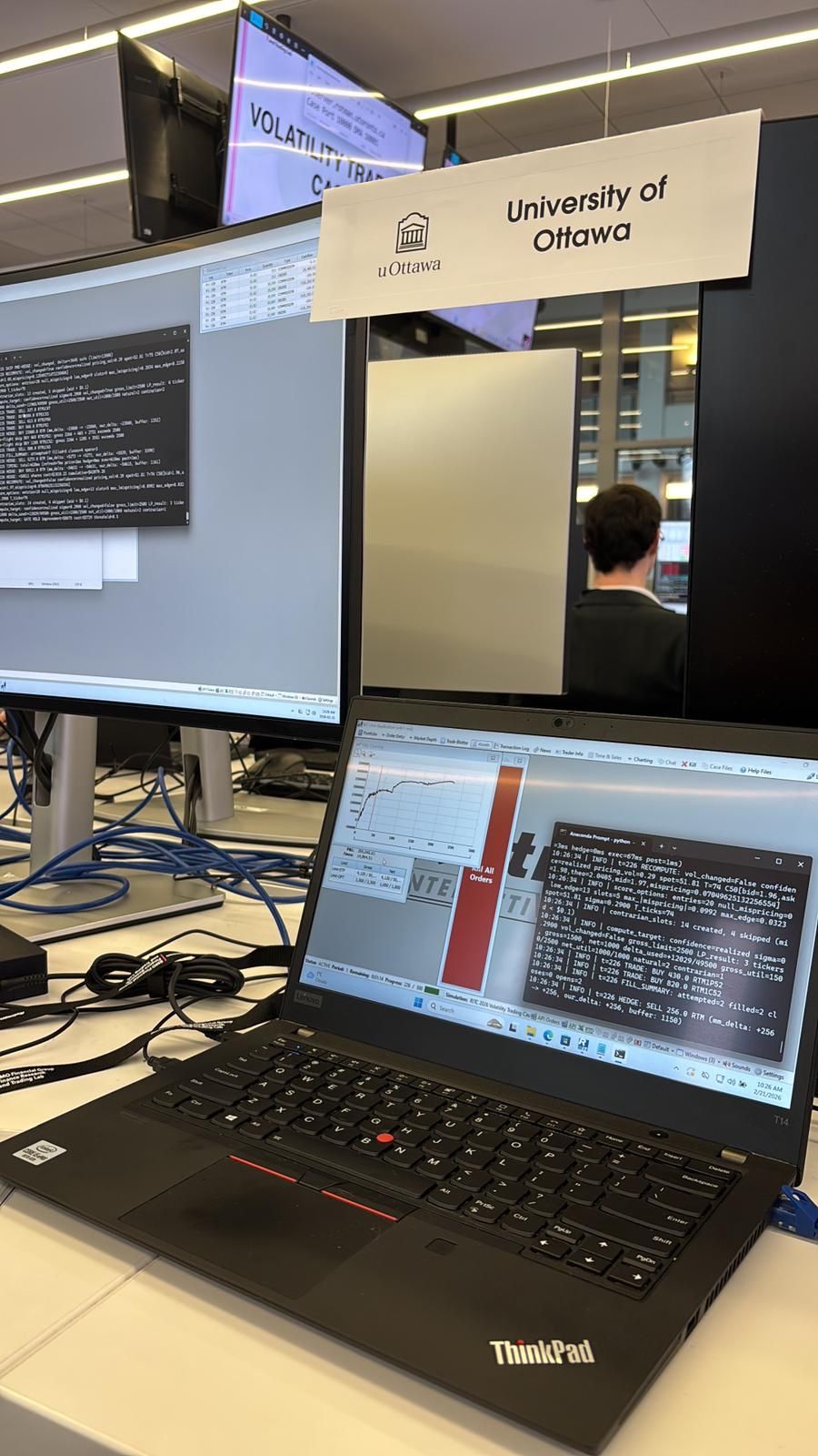 University of Ottawa RITC workstation with the live volatility strategy running beside the competition interface
